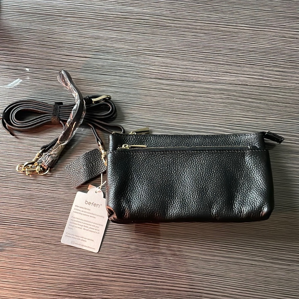 Small black leather crossbody with optional wristlet strap.